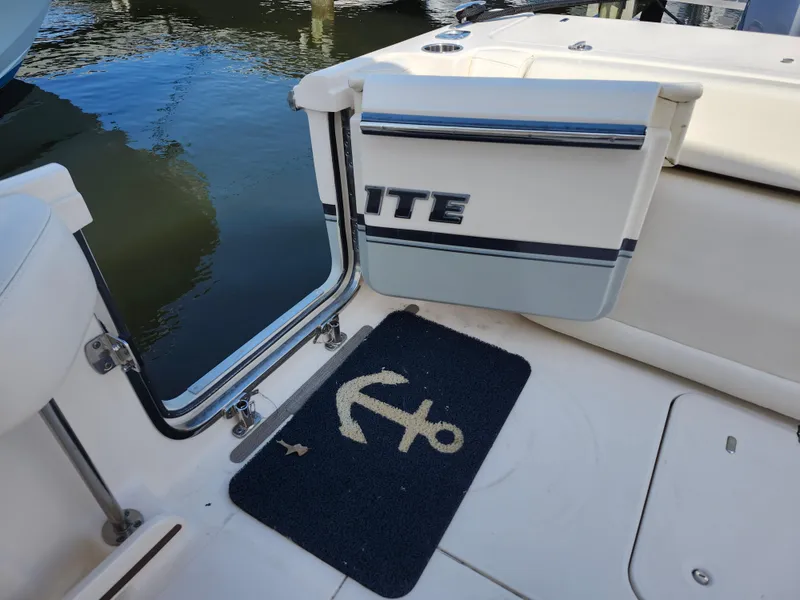 Slide: The Image of 2016 Grady-White Freedom 335 boat with anchor-themed mat on deck. - 34