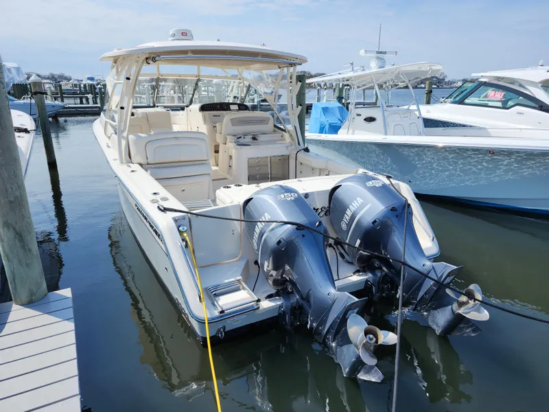 Slide: The Image of 2016 Grady-White Freedom 335 boat with dual Yamaha outboard motors docked at marina. - 37