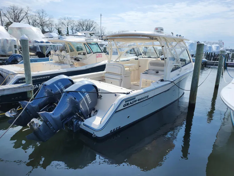 Slide: The Image of 2016 Grady-White Freedom 335 boat docked with twin outboard engines. - 4