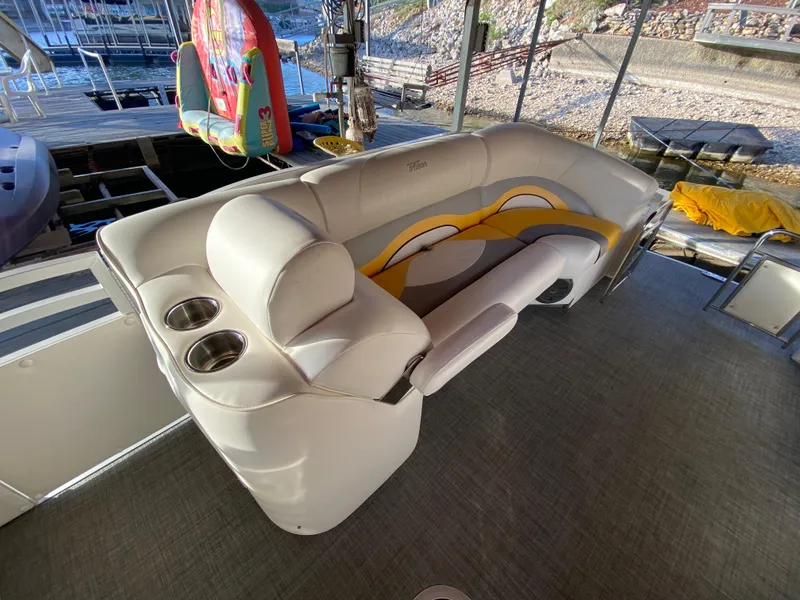 Slide: The Image of 2016 JC NepToon 23TT Sport boat interior with plush seating and cup holders. - 15