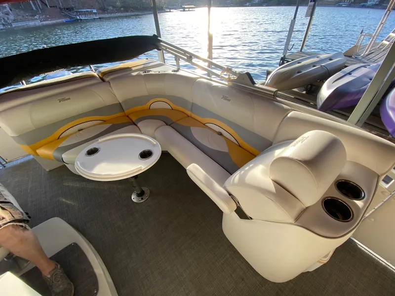 Slide: The Image of Interior of 2016 JC NepToon 23TT Sport pontoon boat with seating and table by the water. - 17
