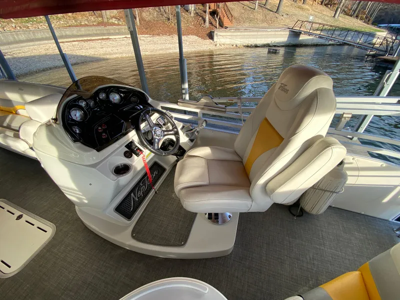 Slide: The Image of 2016 JC NepToon 23TT Sport boat interior with captain's chair and control panel. - 18