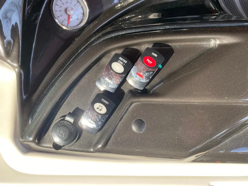 Slide: The Image of Control panel of a 2016 JC NepToon 23TT Sport boat with switches and gauge. - 22