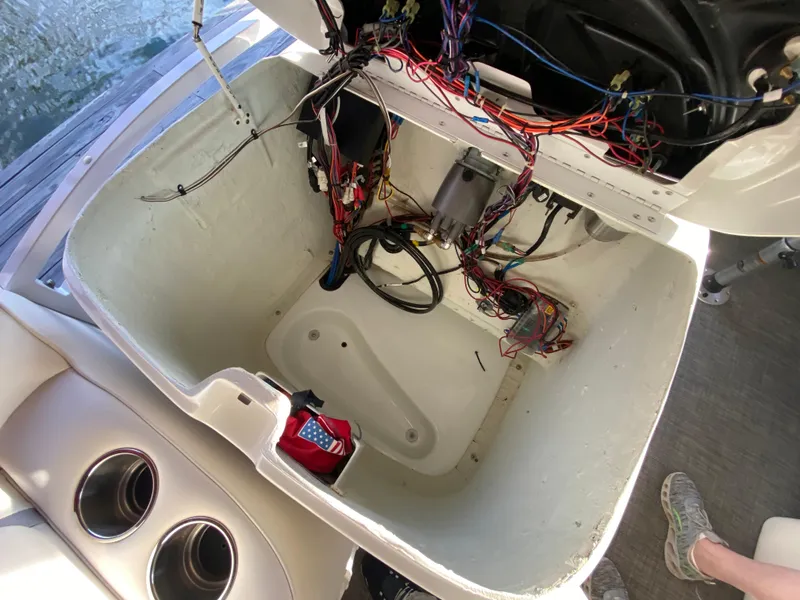 Slide: The Image of Open compartment of a 2016 JC NepToon 23TT Sport boat showing wiring and components. - 26