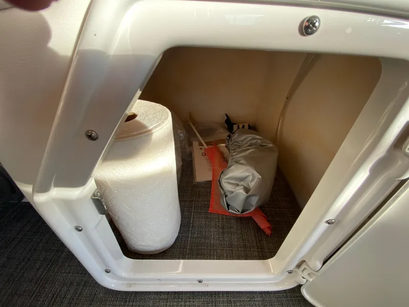 Slide: The Image of Storage compartment in a 2016 JC NepToon 23TT Sport boat with supplies. - 27