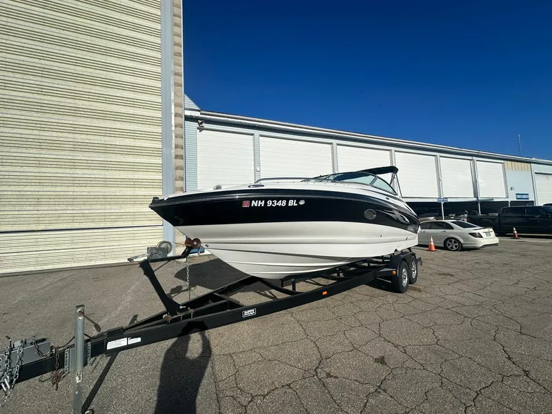 Slide: The Image of 2007 Crownline 260 LS boat on trailer, parked outdoors under clear blue sky. - 1