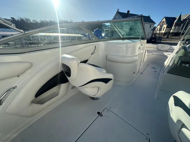 Slide: The Image of 2007 Crownline 260 LS boat interior with white seating and clear windshield. - 11