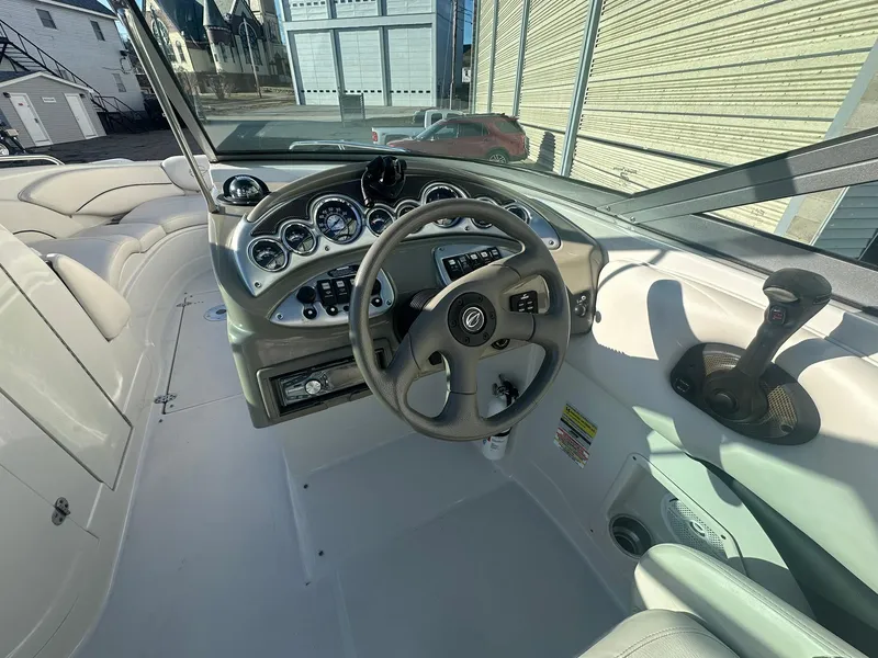 Slide: The Image of 2007 Crownline 260 LS boat dashboard with steering wheel and control panel. - 13