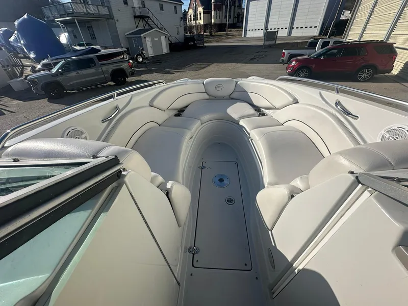 Slide: The Image of 2007 Crownline 260 LS boat interior with white seating and storage compartment. - 14