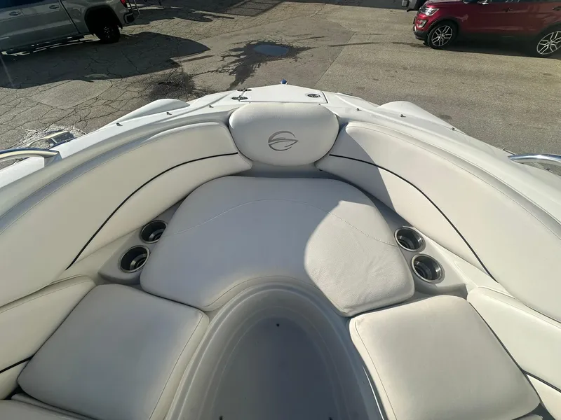 Slide: The Image of 2007 Crownline 260 LS boat interior with white cushioned seating and cup holders. - 17