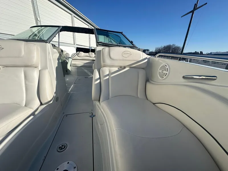 Slide: The Image of 2007 Crownline 260 LS boat interior with white leather seating and clear blue sky. - 19