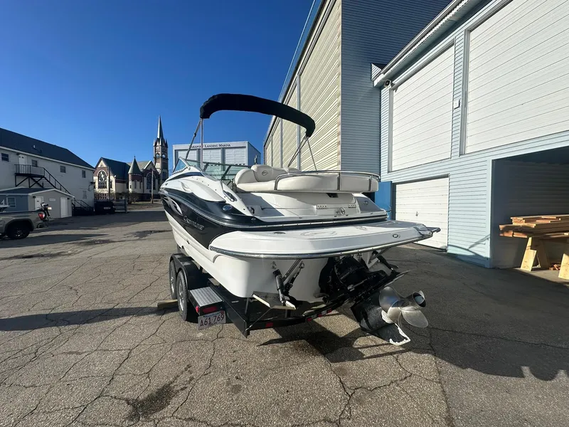 Slide: The Image of 2007 Crownline 260 LS boat on trailer in urban setting, sunny day. - 2