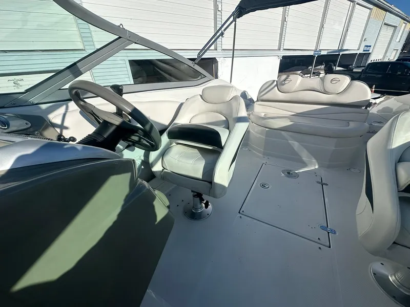 Slide: The Image of 2007 Crownline 260 LS boat interior with steering wheel and seating area. - 20