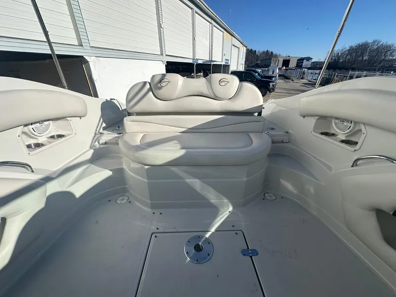 Slide: The Image of 2007 Crownline 260 LS boat interior with white seating and storage compartments. - 22