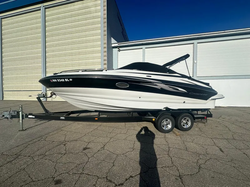 Slide: The Image of 2007 Crownline 260 LS boat on trailer, parked outside a storage facility. - 3