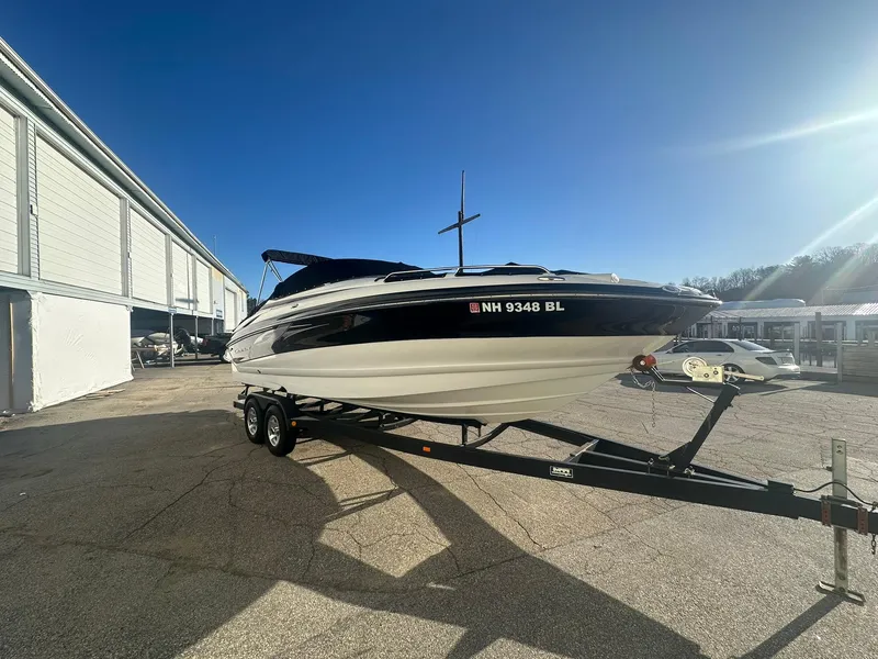 Slide: The Image of 2007 Crownline 260 LS boat on trailer, parked outdoors under clear blue sky. - 5
