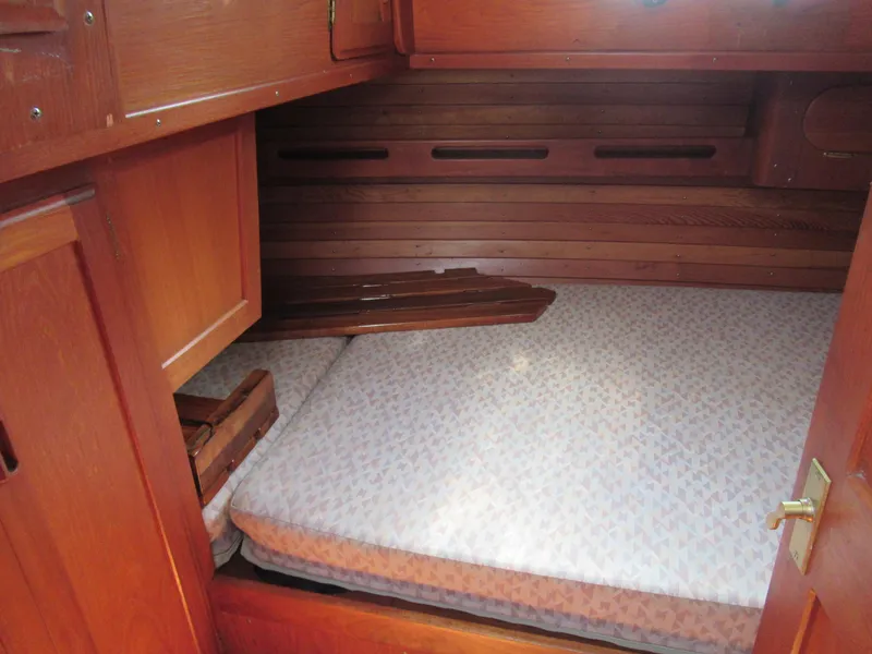 Slide: The Image of Cozy cabin interior of 1980 Fast Passage 39 sailboat with wooden finish and mattress. - 10