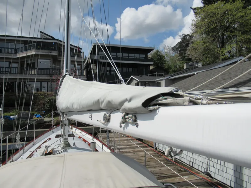Slide: The Image of Sailboat deck view of 1980 Fast Passage 39, docked near modern buildings. - 16