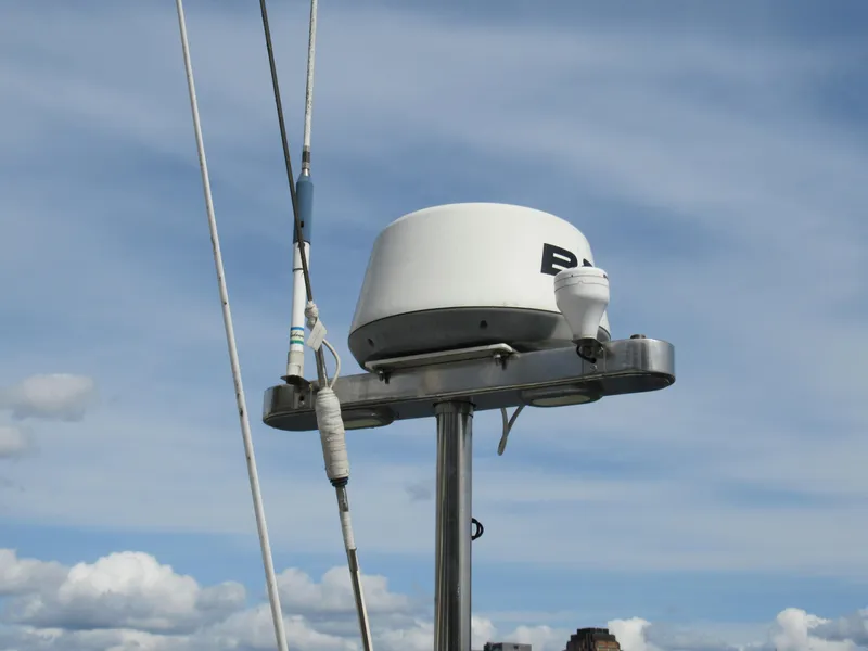 Slide: The Image of Radar equipment on a 1980 Fast Passage 39 sailboat against a cloudy sky. - 17