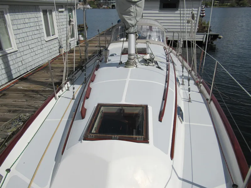 Slide: The Image of 1980 Fast Passage 39 sailboat docked, showing deck and cabin details. - 19