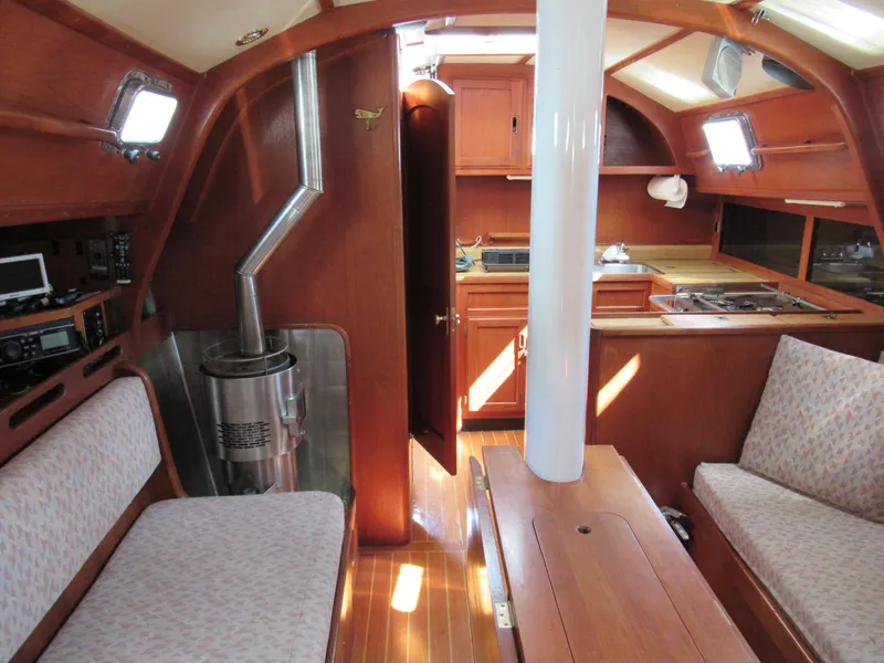 Slide: The Image of Interior of 1980 Fast Passage 39 sailboat with wood finish and cozy seating area. - 2