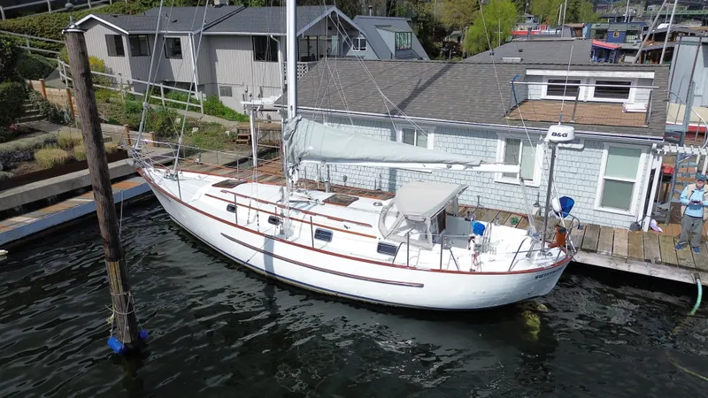 Slide: The Image of Sailboat docked by waterfront homes, Fast Passage 39, 1980 model. - 20