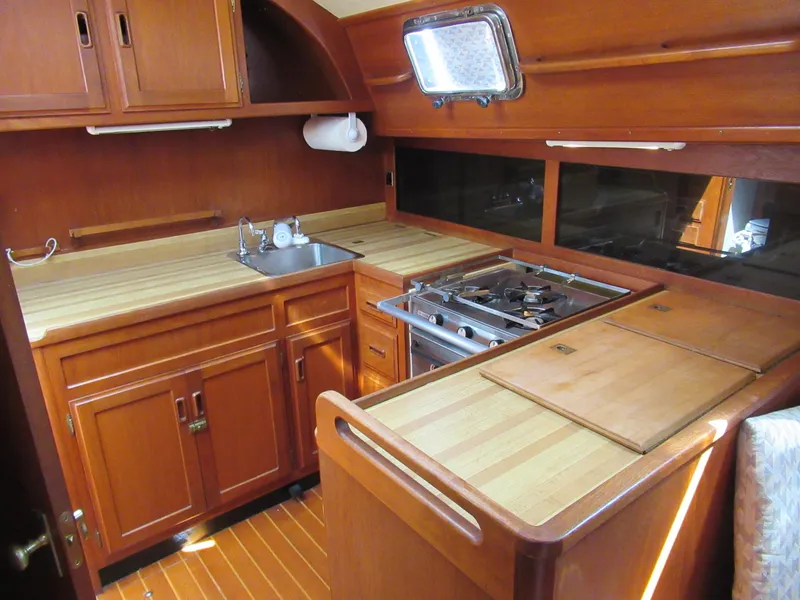 Slide: The Image of Cozy wooden galley in 1980 Fast Passage 39 sailboat with stove, sink, and ample storage. - 3