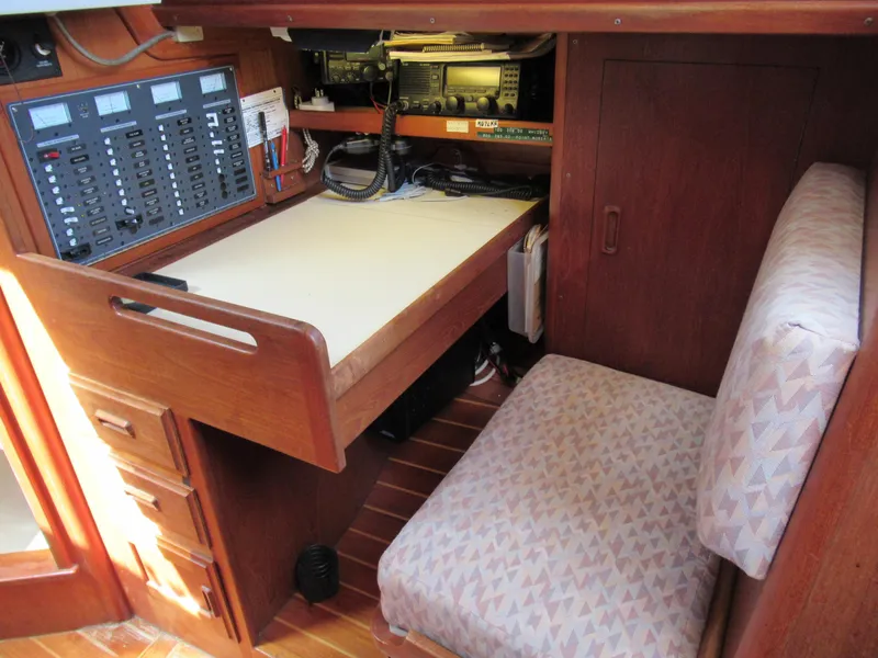 Slide: The Image of Navigation station in a 1980 Fast Passage 39 sailboat with control panel and seating. - 7
