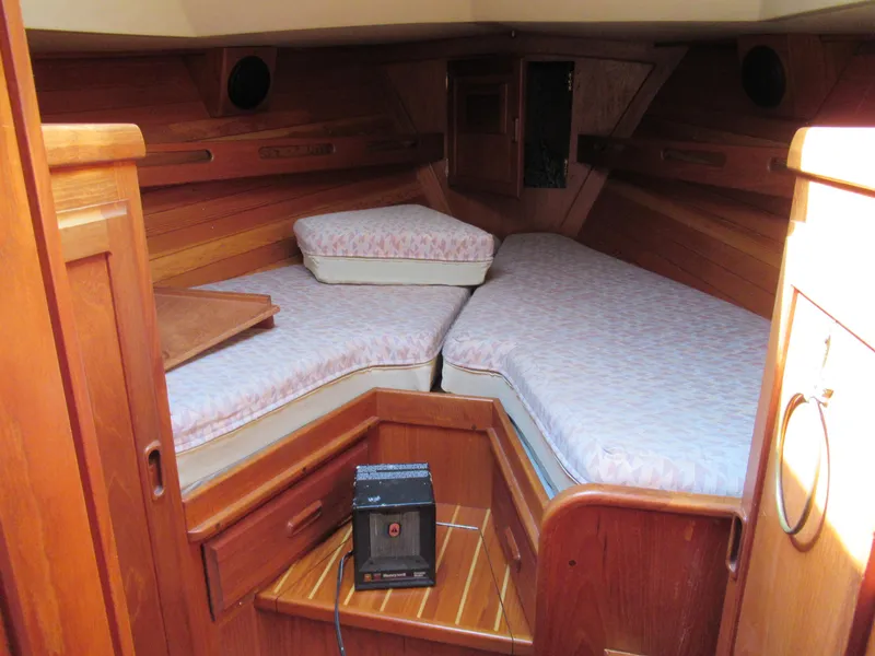 Slide: The Image of Cozy cabin interior of 1980 Fast Passage 39 sailboat with wooden finish and twin berths. - 9