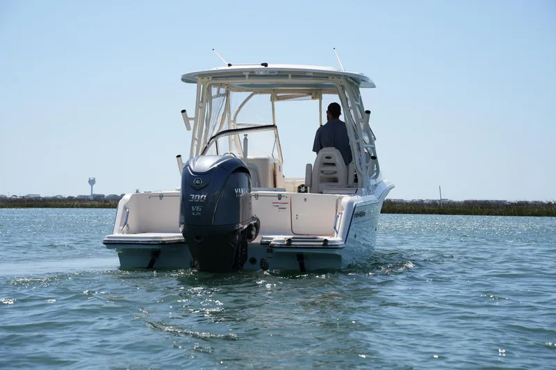 Slide: The Image of 2022 Grady-White Freedom 235 boat on water, rear view with Yamaha engine. - 11