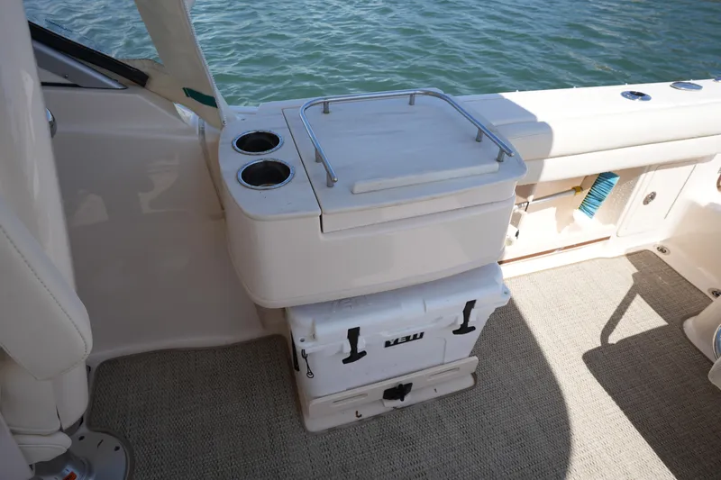 Slide: The Image of 2022 Grady-White Freedom 235 boat interior with storage and cup holders. - 19