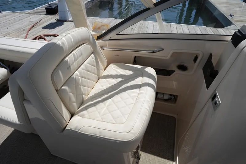 Slide: The Image of 2022 Grady-White Freedom 235 boat interior with luxurious white seating. - 23