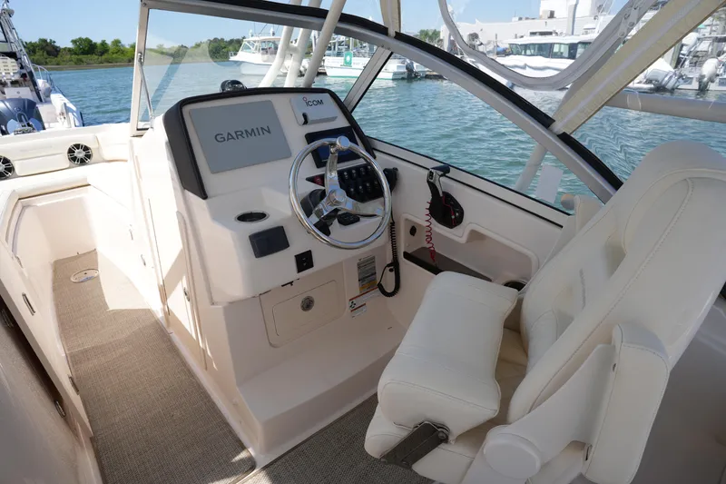 Slide: The Image of 2022 Grady-White Freedom 235 boat cockpit with Garmin navigation system. - 24