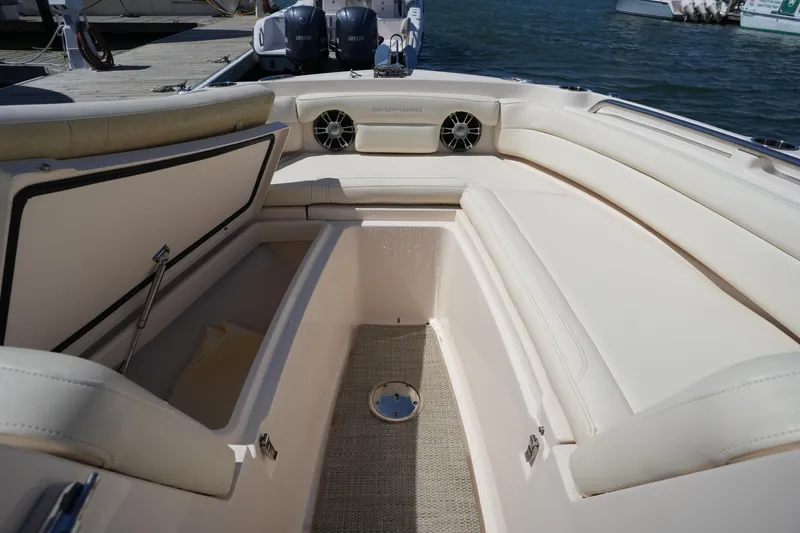Slide: The Image of 2022 Grady-White Freedom 235 boat interior with beige seating and storage compartments. - 33