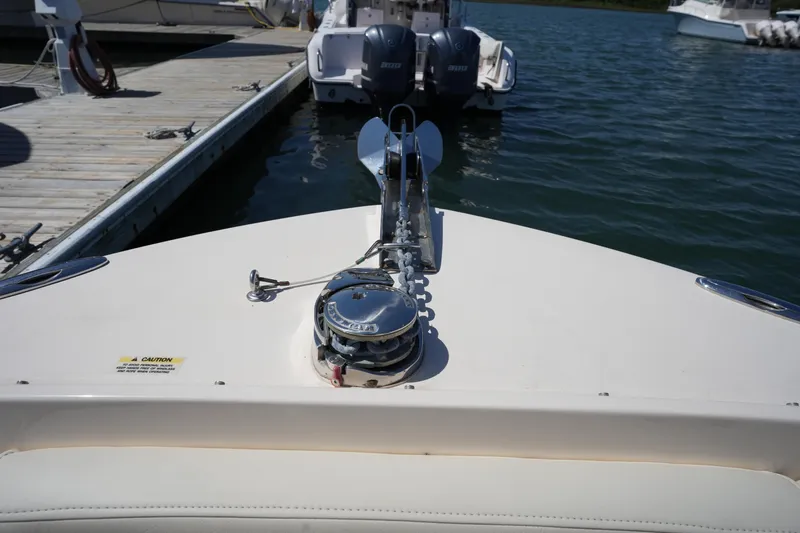 Slide: The Image of 2022 Grady-White Freedom 235 boat docked, showcasing anchor system and dual engines. - 35