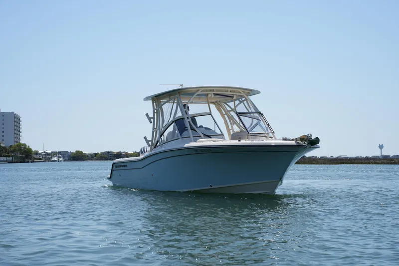 Slide: The Image of 2022 Grady-White Freedom 235 boat cruising on calm waters. - 4