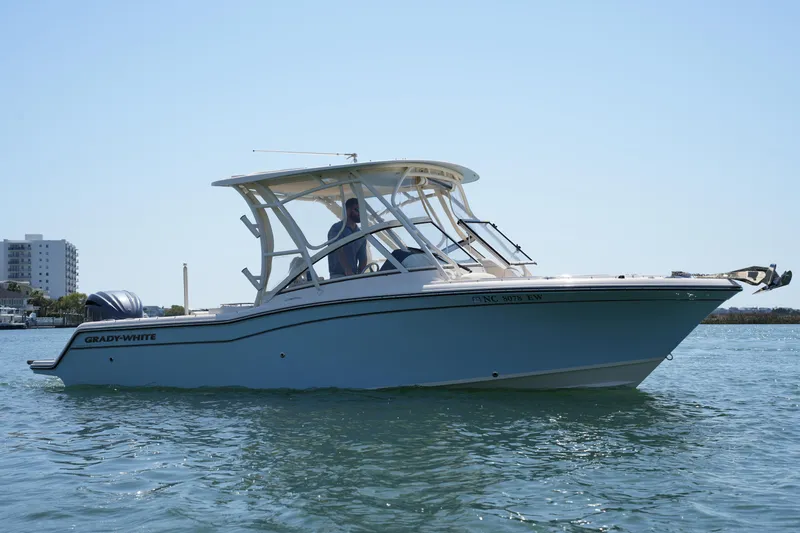 Slide: The Image of 2022 Grady-White Freedom 235 boat on calm water, side view. - 6