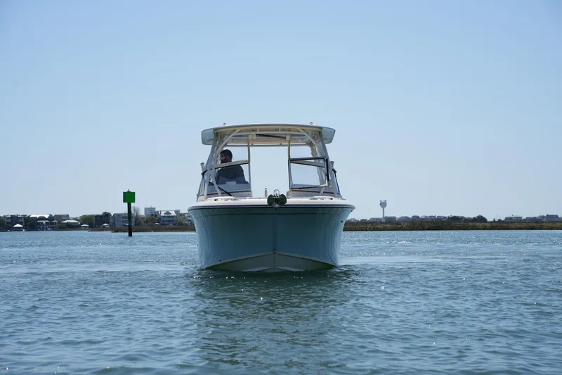 Slide: The Image of 2022 Grady-White Freedom 235 boat on calm water, front view. - 8
