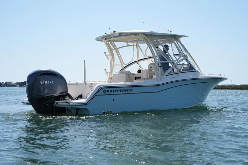 Slide: The Image of 2022 Grady-White Freedom 235 boat on water, featuring Yamaha outboard motor. - 9