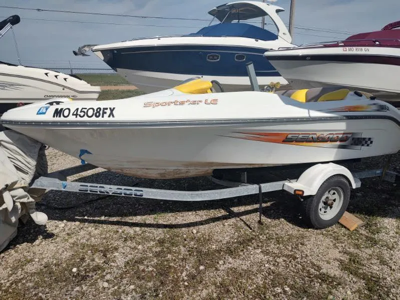 Slide: The Image of 2004 Sea-Doo Sportster boat on trailer, parked outdoors, with visible registration number. - 1