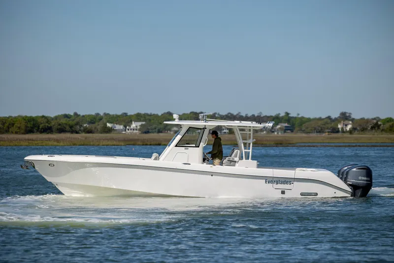 Slide: The Image of 2017 Everglades 355 Tournament boat cruising on a calm lake. - 1