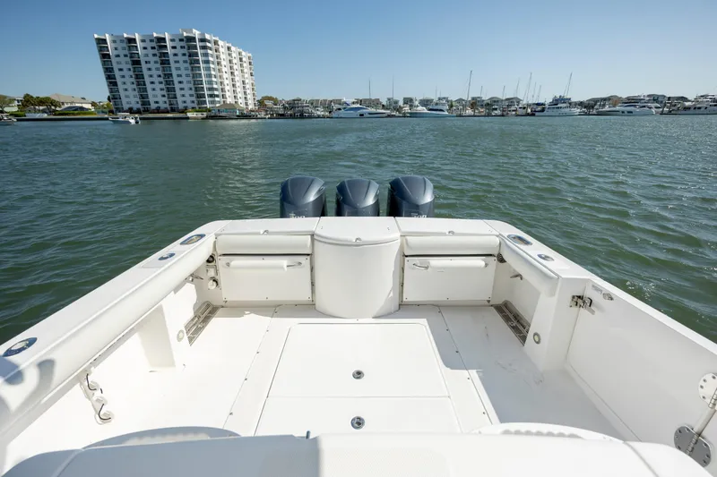 Slide: The Image of 2017 Everglades 355 Tournament boat on water, with marina and buildings in background. - 10