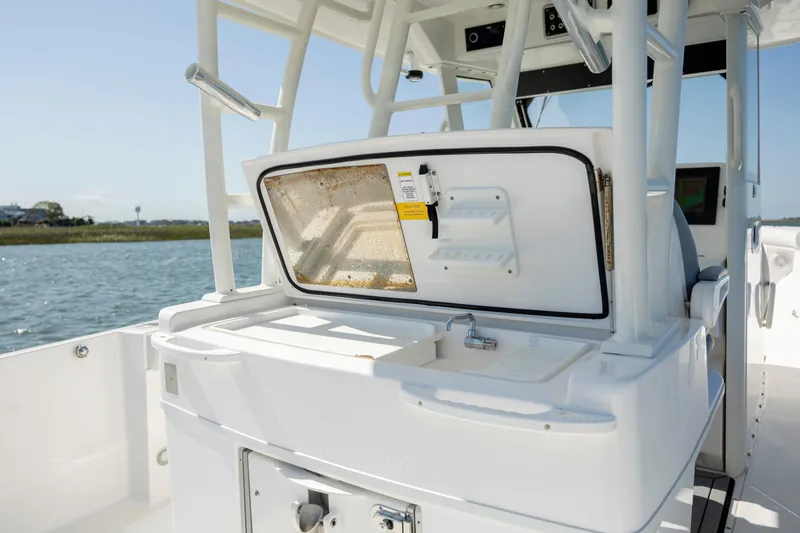 Slide: The Image of 2017 Everglades 355 Tournament boat interior with open storage compartment. - 17