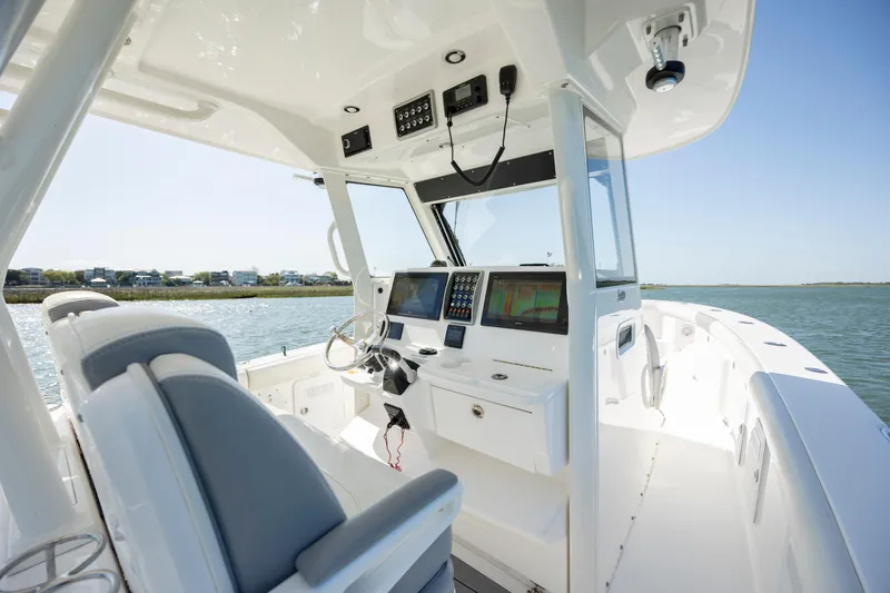 Slide: The Image of 2017 Everglades 355 Tournament boat cockpit with advanced navigation systems and comfortable seating. - 18