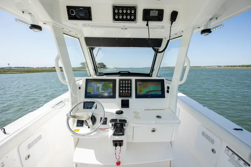 Slide: The Image of 2017 Everglades 355 Tournament boat cockpit with advanced navigation systems on open water. - 19