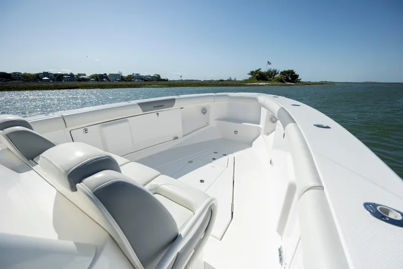 Slide: The Image of 2017 Everglades 355 Tournament boat interior with seating, on calm water. - 22