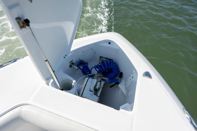 Slide: The Image of 2017 Everglades 355 Tournament boat storage compartment with coiled blue hose. - 24