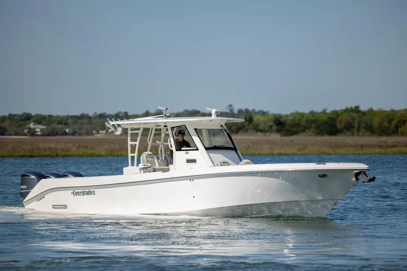 Slide: The Image of 2017 Everglades 355 Tournament boat cruising on a calm lake under clear skies. - 8