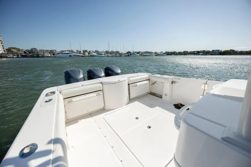 Slide: The Image of 2017 Everglades 355 Tournament boat deck with triple outboard motors on calm water. - 9