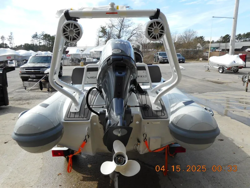 Slide: The Image of 2025 Highfield Sport 420 boat with motor and speakers, docked outdoors. - 8